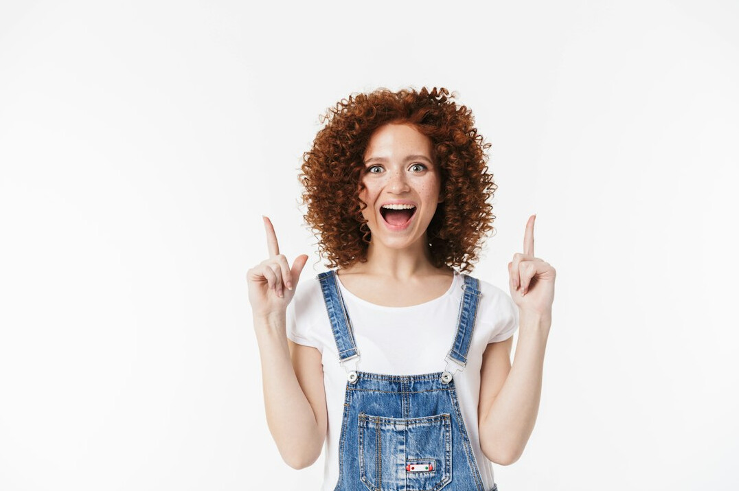 Portrait of a cheerful young woman with curly hair