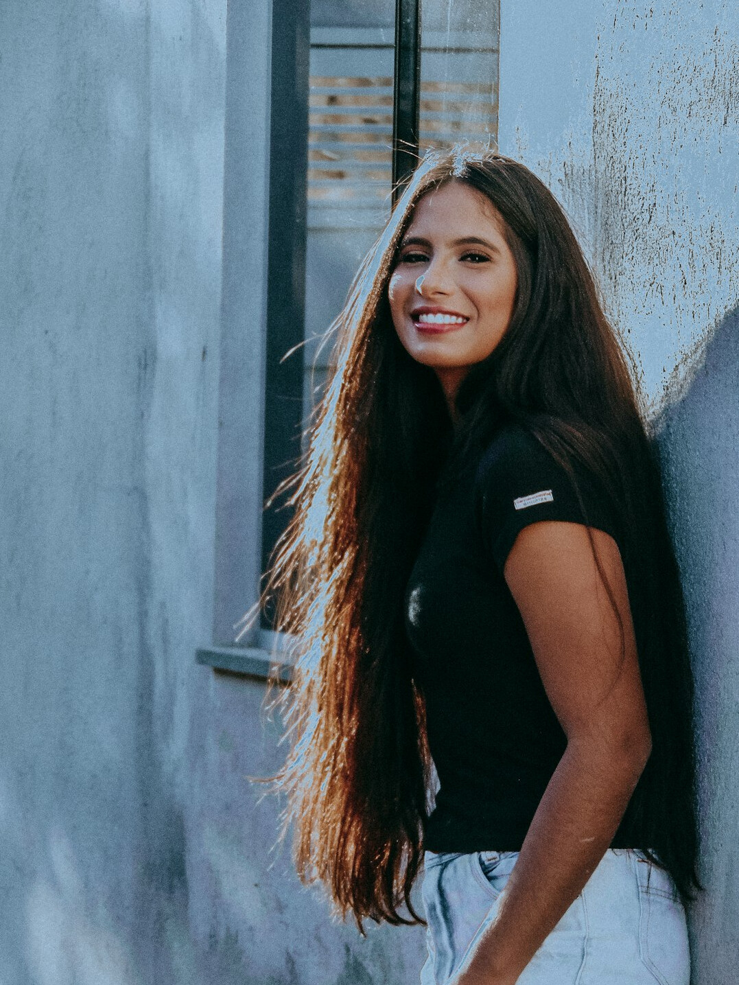 Portrait of a young woman with long hair smiling